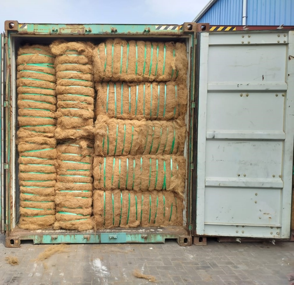 Coir bales tightly strapped inside container