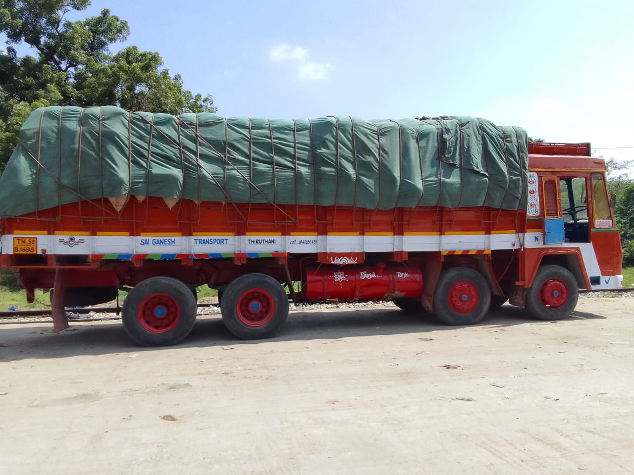 Commodity truck covered with green tarpaulin